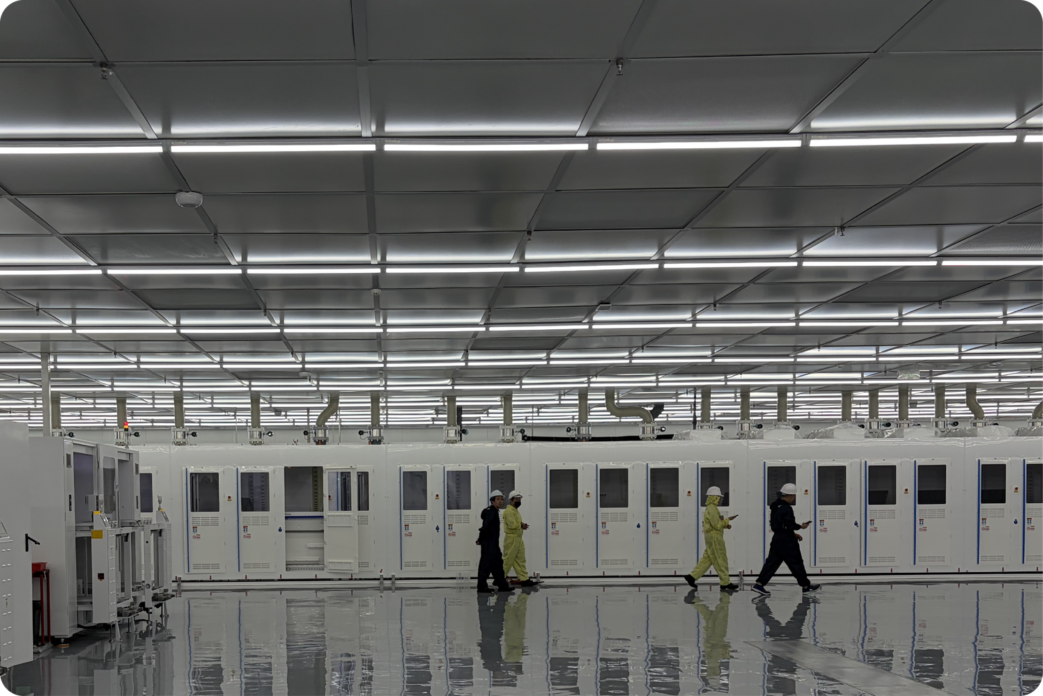 Solar cell manufacturing cleanroom with operators walking between production lines